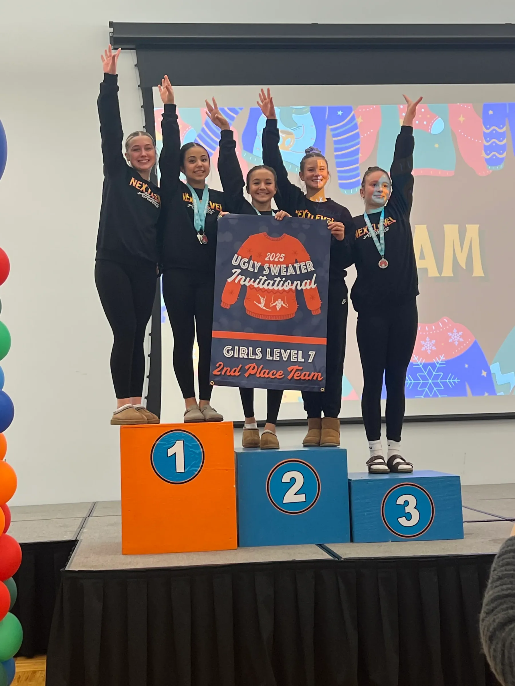 Next Level Level 7 gymnastics team on the second-place podium